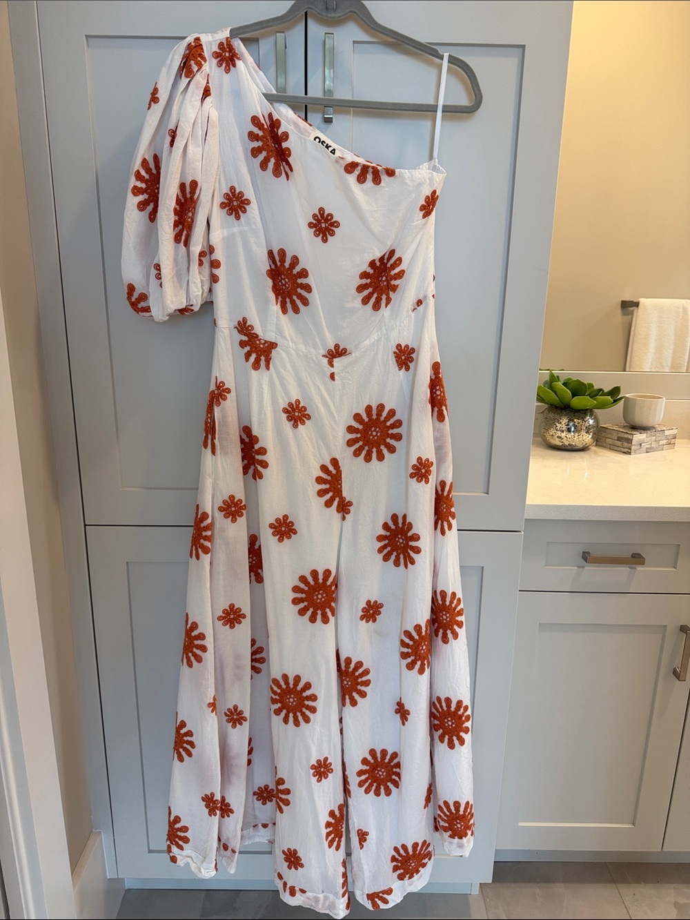 OSKA RARE White One-Shoulder Maxi Pantsuit with Rust Floral Appliqué
